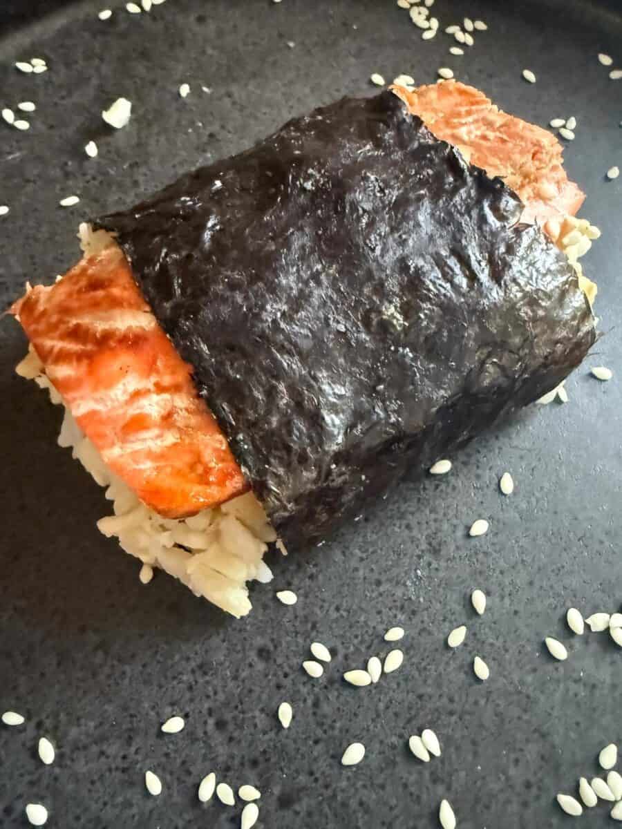 A completed salmon musubi on a plate.