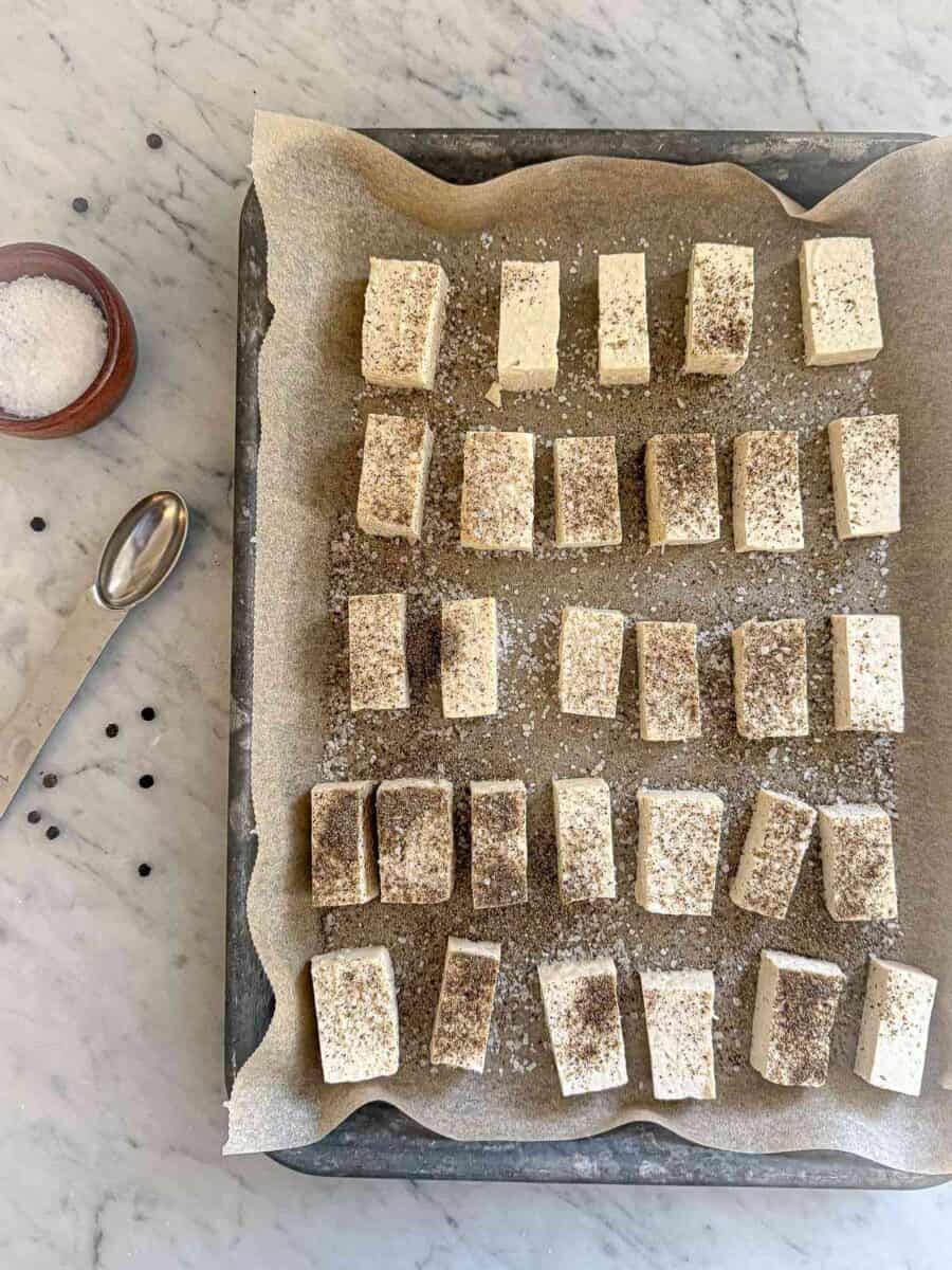 Tofu cut up and ready to bake on a cookie sheet