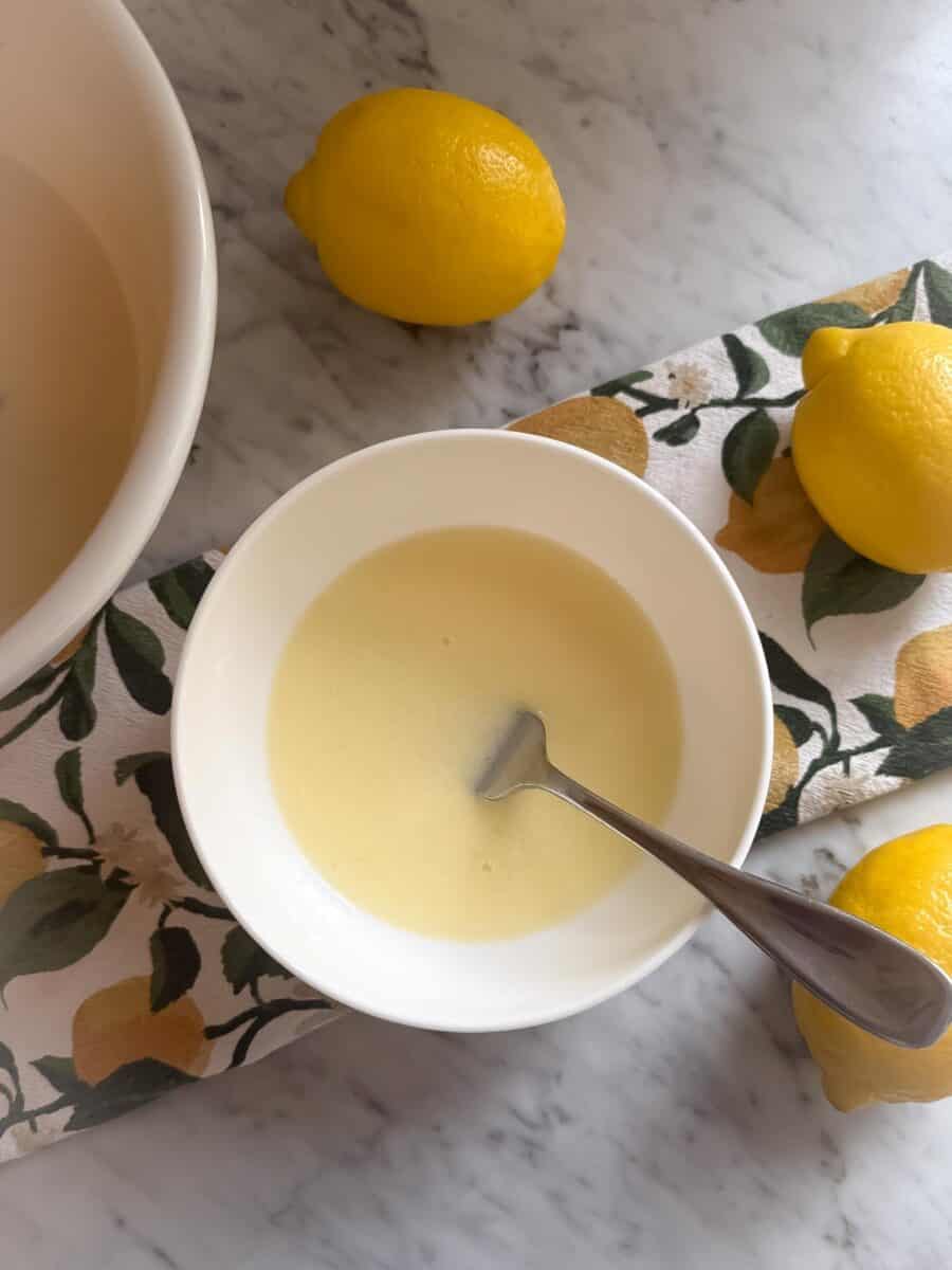 Lemon juice and corn starch combined in a bowl using a fork.