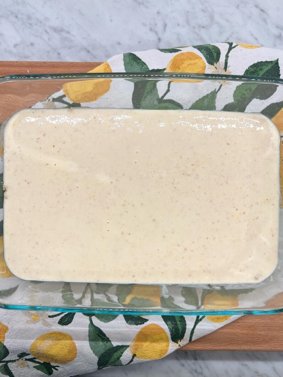 Lemon filling on top of prepared almond crust ready to bake