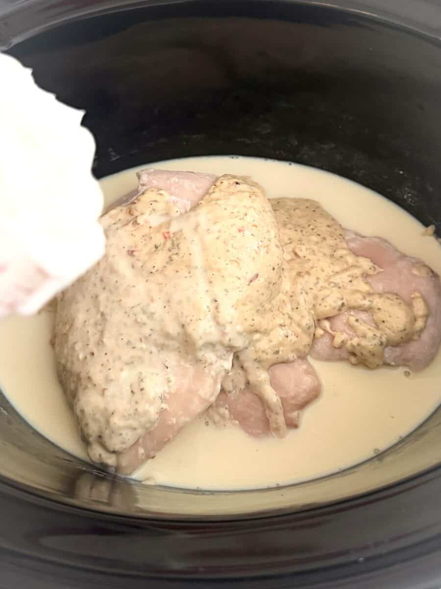 Sauce and chicken for Crock Pot Garlic Parmesan Chicken Pasta in the slow cooker