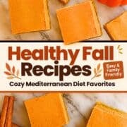 Overhead view of pumpkin pie bars with a golden crust scattered on a white marble surface, with a small orange pumpkin and cinnamon sticks nearby. Text overlay reads “Healthy Fall Recipes – Cozy Mediterranean Diet Favorites – Easy & Family Friendly” with mediterraneanforlife.com at the bottom.